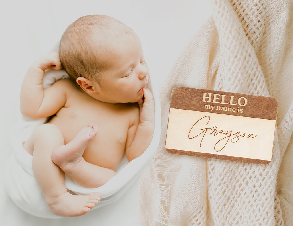 Baby name announcement with "hello my name is" name tag wood sign